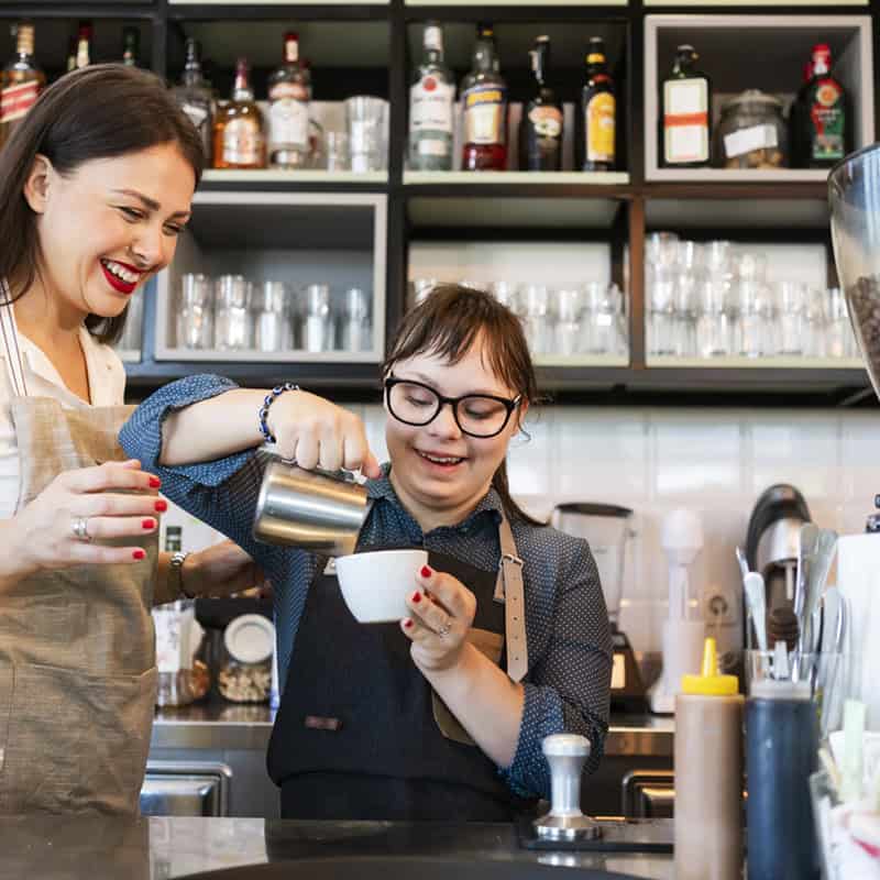 Young woman with Down Syndrome working at cafe